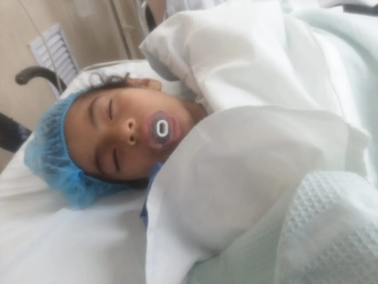 Haviv asleep in a hospital bed