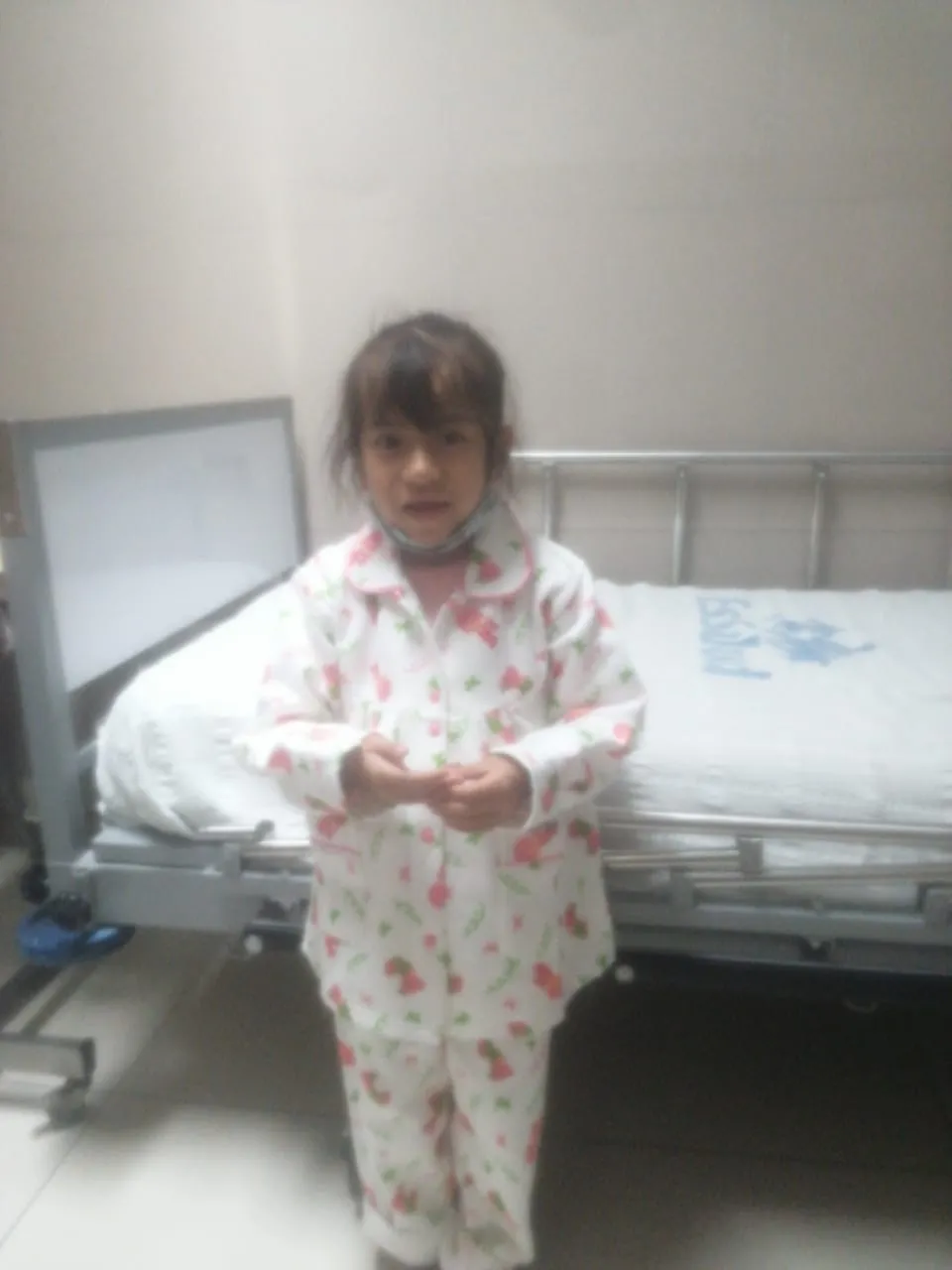 Haviv standing beside a hospital bed